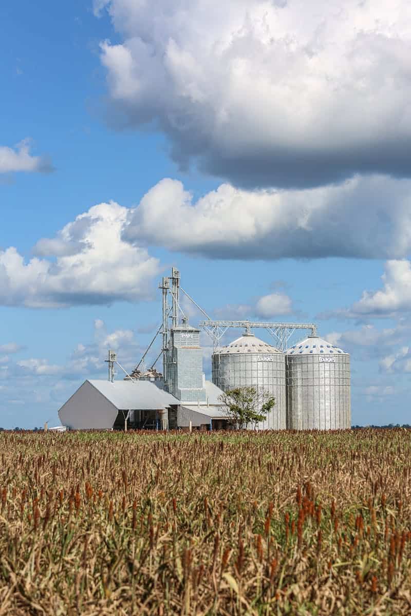 Scenic view of agricultural silos and barn in Paragominas, Brazil under a cloudy sky.